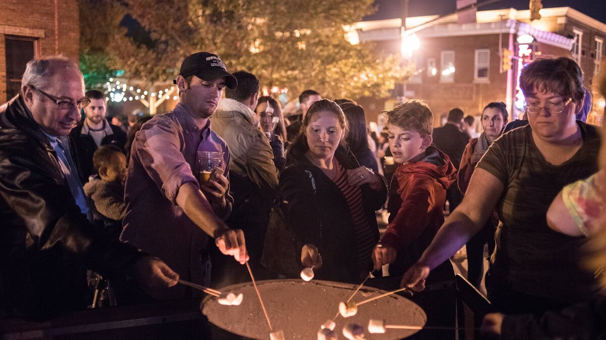 Folks roast marshmallows over a barrel fire during a past Vista Lights celebration.
