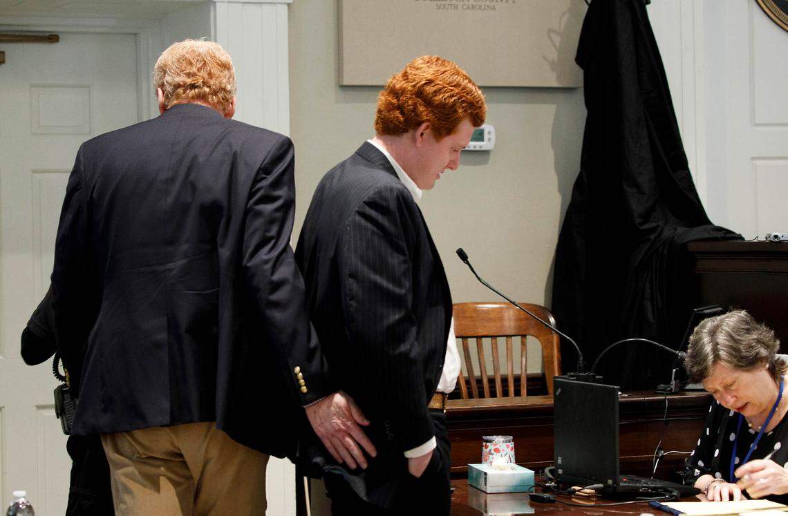 Alex Murdaugh gives his son Buster Murdaugh a pat during a break in testimony during trial at the Colleton County Courthouse in Walterboro, Tuesday, Feb. 21, 2023. Grace Beahm Alford/The Post and Courier/Pool