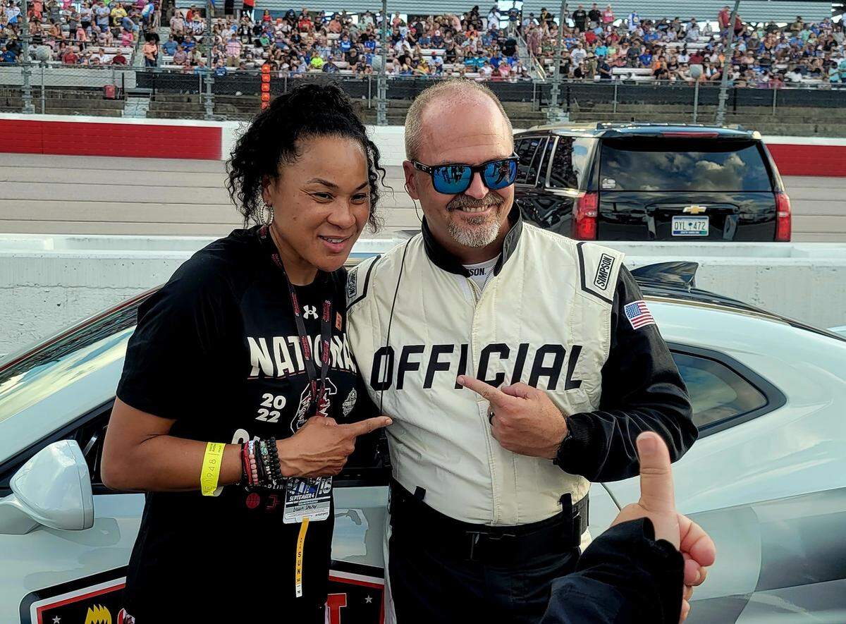 South Carolina women’s basketball coach Dawn Staley, left, poses for a photo with NASCAR official before the start of The Cookout Southern 500 on Sunday, Sept. 4, 2022, at Darlington Raceway.