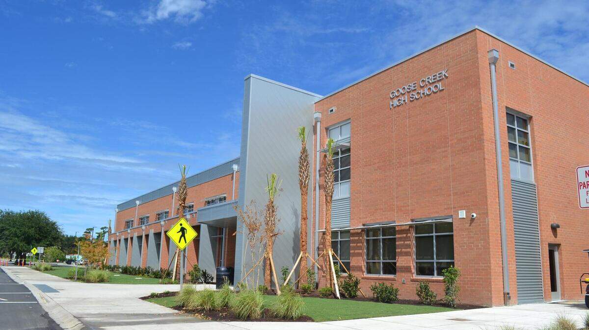 A man wanted for trying to lure students away from Goose Creek High School turned himself in to deputies in South Carolina.