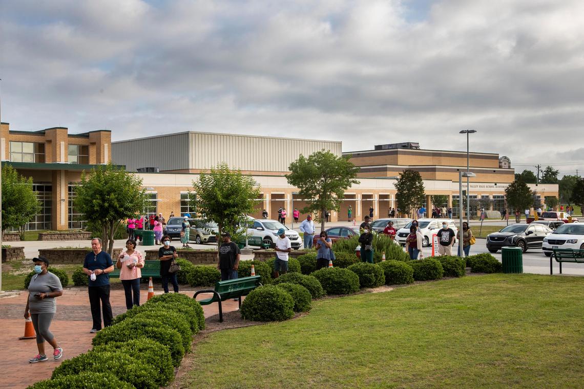Voters wait to vote at the combined Briarwood, Polo Road, Spring Valley West, Mallet Hill and Valhalla voting location at Spring Valley High School on Tuesday, June 9, 2020. At 8 a.m., the line went around to the other side the building.