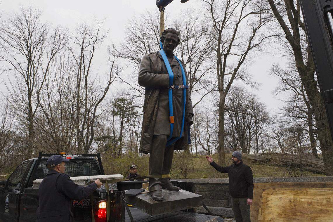 The statue of Dr. J. Marion Sims is removed by crane on Tuesday, April 17, 2018, in New York's Central Park.  Sims was known as the father of modern gynecology, but critics say his use of female slaves as experimental subjects was unethical. The statue is being moved to Green-Wood Cemetery in Brooklyn, where Sims is buried.