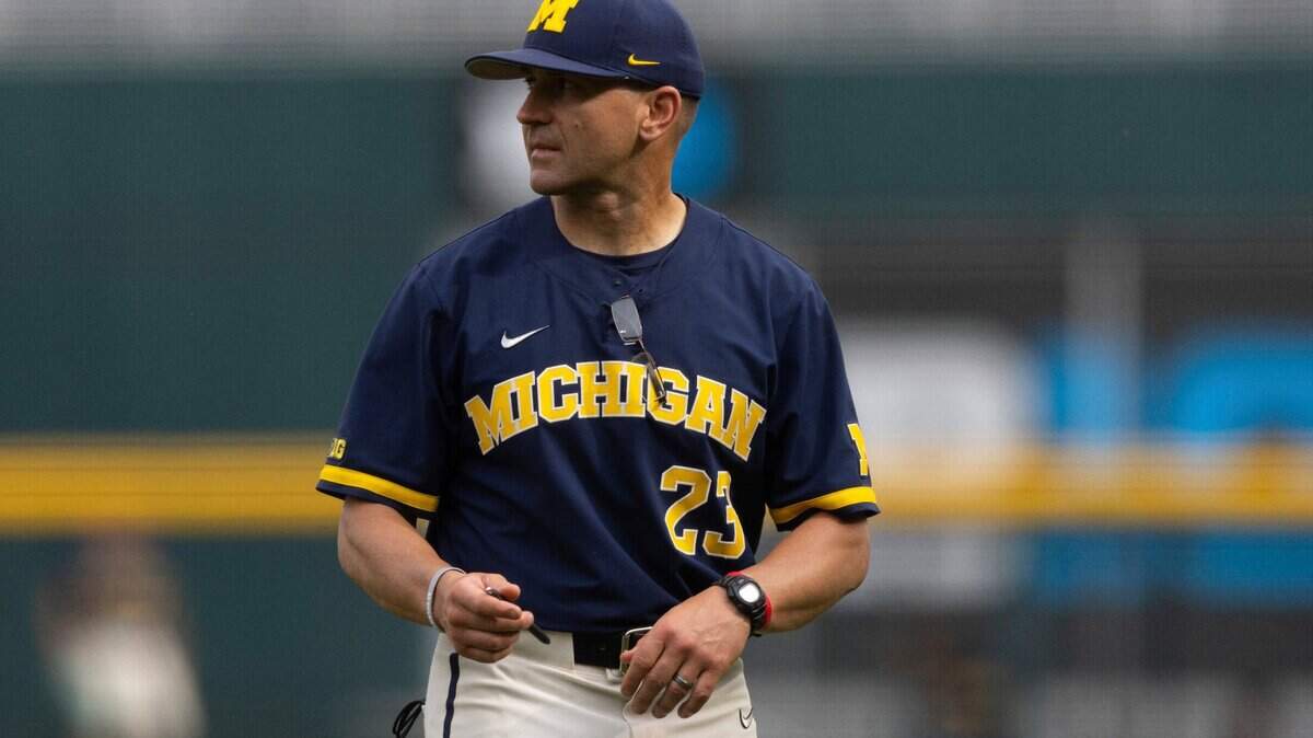 Michigan head coach Erik Bakich returns to the dugout after arguing with the umpires following a play at first base against Rutgers in the first inning of the NCAA college Big Ten baseball championship game Sunday, May 29, 2022, at Charles Schwab Field in Omaha, Neb. (AP Photo/Rebecca S. Gratz)