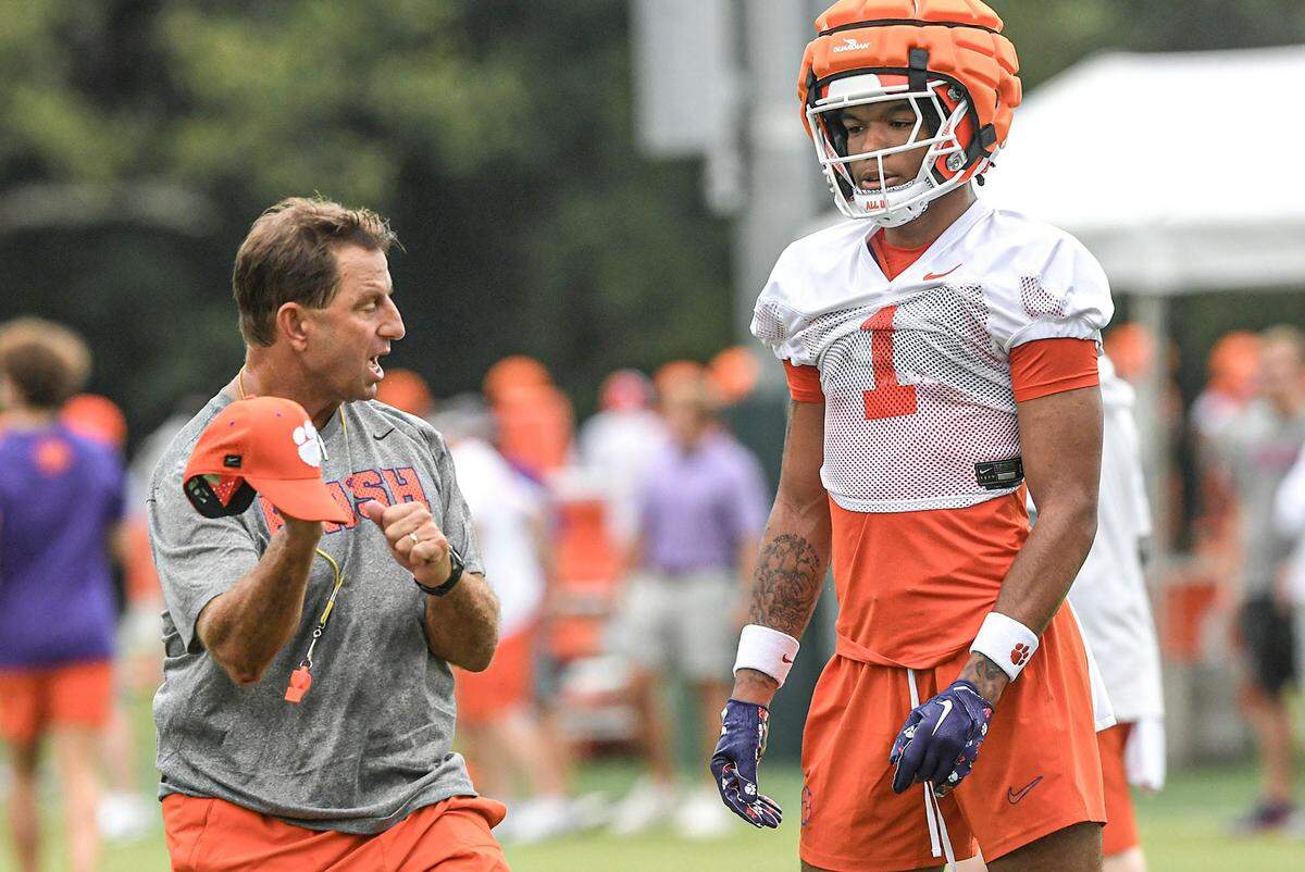 Clemson head coach Dabo Swinney talks with Clemson wide receiver T.J. Moore (1) during the Clemson first football August practice in Clemson, S.C. Thursday August 1, 2024.