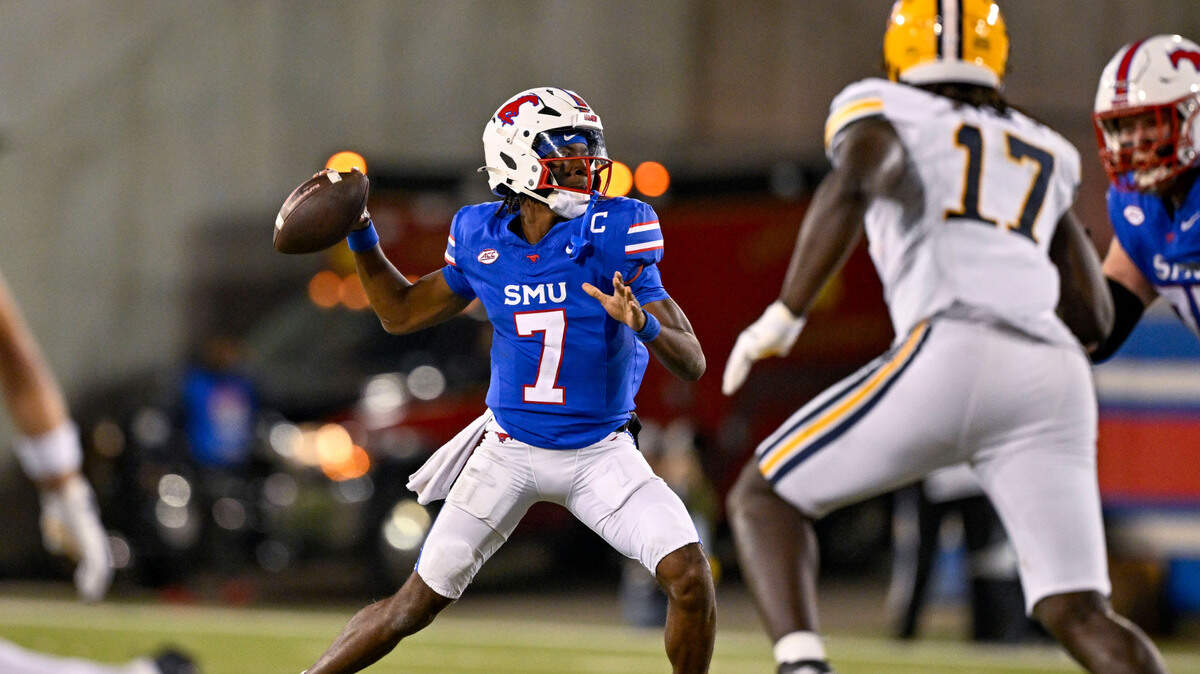 Nov 30, 2024; Dallas, Texas, USA; Southern Methodist Mustangs quarterback Kevin Jennings (7) passes for a touchdown to running back Brashard Smith (not pictured) during the second half at Gerald J. Ford Stadium.