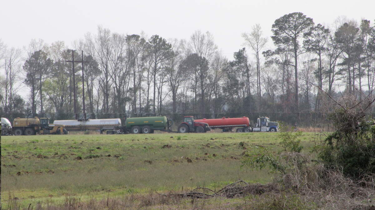 Sludge is often applied as fertilizer to farmland in South Carolina. It’s considered good for plant growth, but there are growing questions about whether toxic materials are in the sludge. The state has few limits on toxic chemicals in the waste material. New rules from the Legislature could make adopting new sludge rules more difficult, environmentalists say. This photo, from March 2023, shows a procession of trucks and heavy machinery involved in sludge spreading in Darlington County.