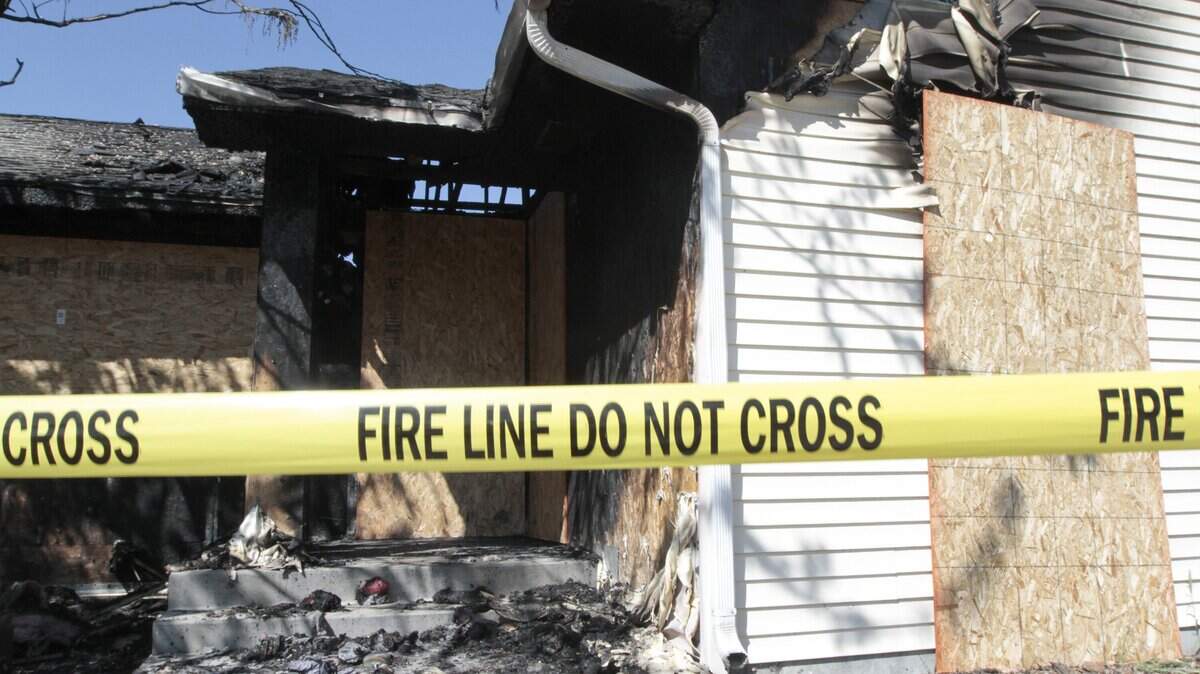 File image of a fire line scene tape at house fire.