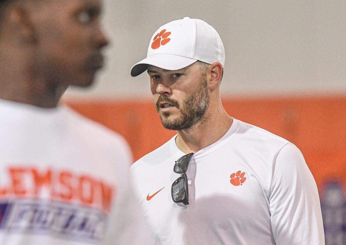 Clemson offensive coordinator Garrett Riley runs a drill and watches campers during the first of the 2023 Dabo Swinney High School Camps at the practice facilities at Clemson University in Clemson, S.C. Wednesday, May 31, 2023. There are camps for High School (rising 8th-12th graders), and Youth camps. The camps provide campers with football fundamentals for various skill positions, with no-contact, no pads, or helmets.
