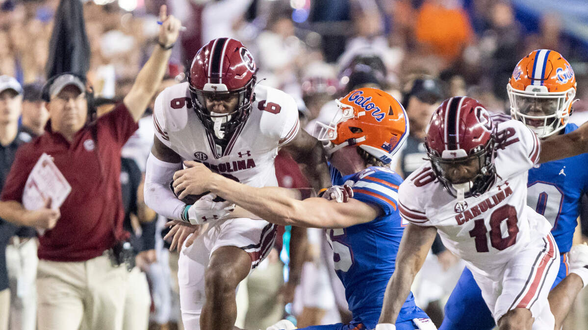 South Carolina Gamecocks wide receiver Josh Vann (6) carries the ball while fending off the tackle of Florida Gators safety Kamar Wilcoxson (26) at Ben Hill Griffin Stadium in Gainesville, FL on Saturday, Nov. 12, 2022.