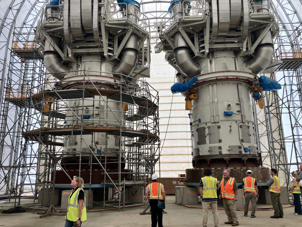 Massive equipment for a failed nuclear construction project northwest of Columbia is scattered across the V.C. Summer atomic power site. In this picture, an advisory board tours a temporary storage building with two 39-foot high reactor vessel heads.