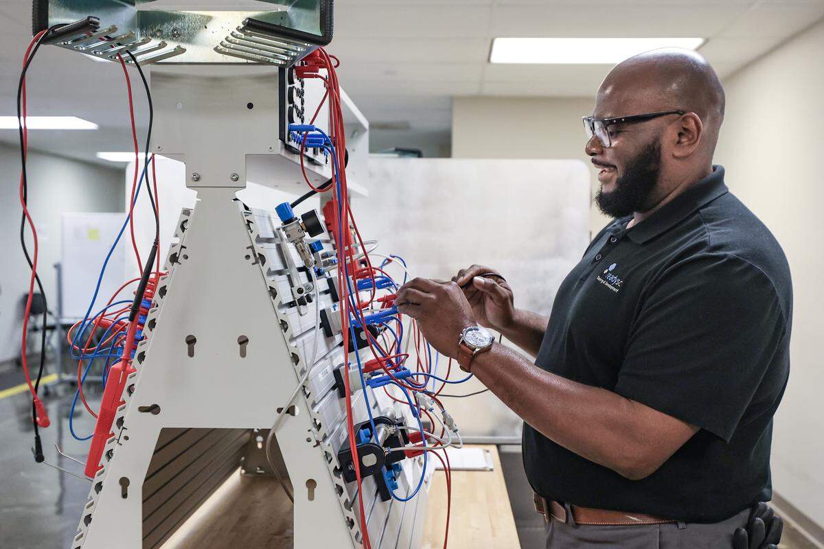 ReadySC instructor Eric Dorsey demonstrates the use of a pneumatic tester in the new training area at the Cornerstone Economic Development and Workforce Training Center at Midlands Technical College. The center is being used to screen applicants for Scout Motors.