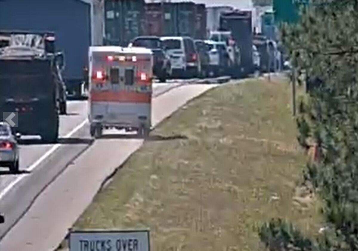 An ambulance navigates through a traffic jam following a crash on a highway in Columbia.