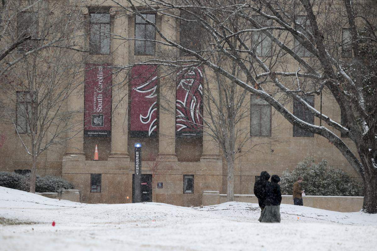 People walk on the USC campus on Saturday, Jan. 31, 2026. Snow is expected to fall all day in the Midlands.