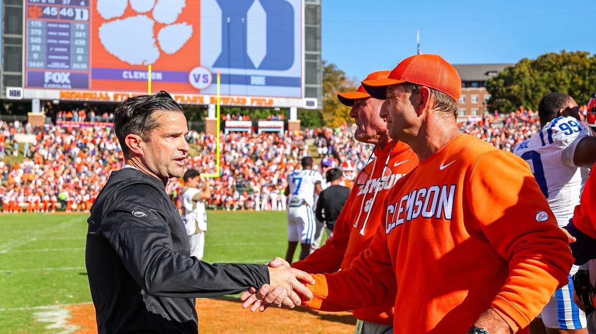 CLEMSON, SOUTH CAROLINA - NOVEMBER 01: Head Coach Manny Diaz of the Duke Blue Devils greets Head Coach Dabo Swinney of the Clemson Tigers at midfield after a football game at Memorial Stadium on November 01, 2025 in Clemson, South Carolina. (Photo by David Jensen/Getty Images)