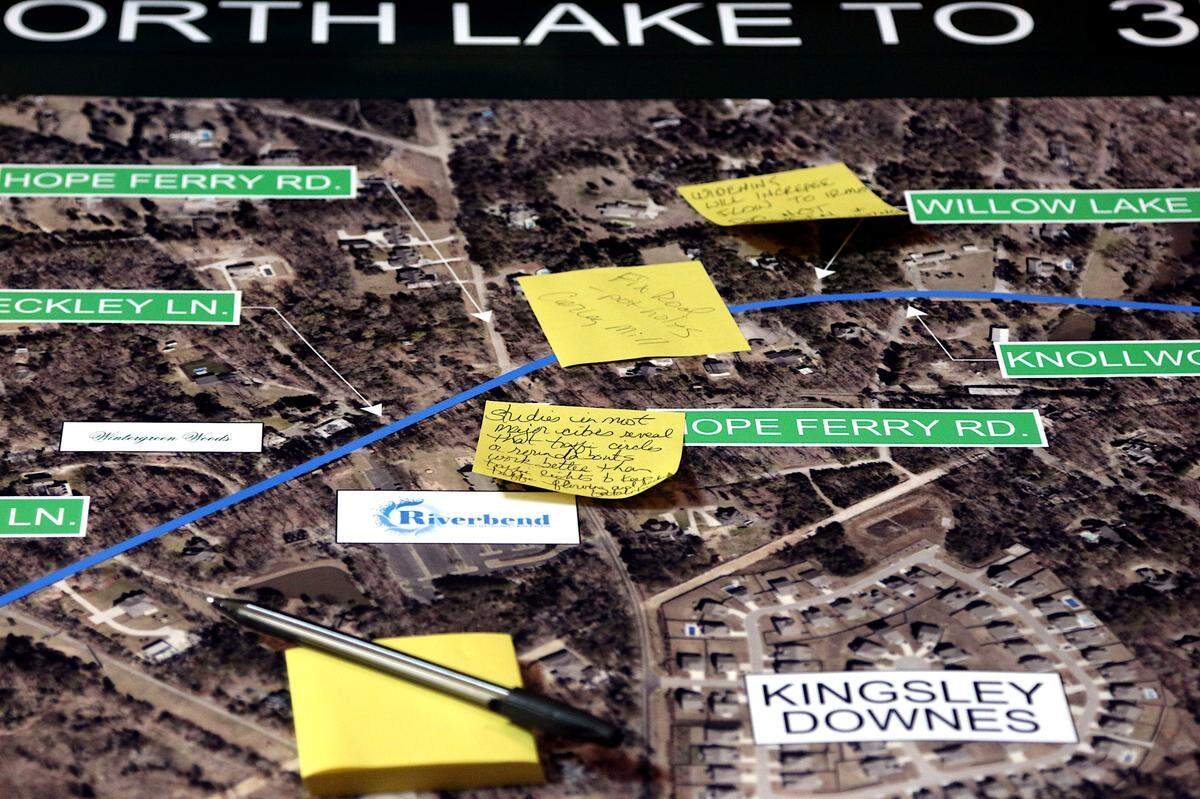Residents attach their thoughts on improving Corley Mill Road to large maps at a recent public meeting at Riverbend Community Church. Aug. 1, 2024