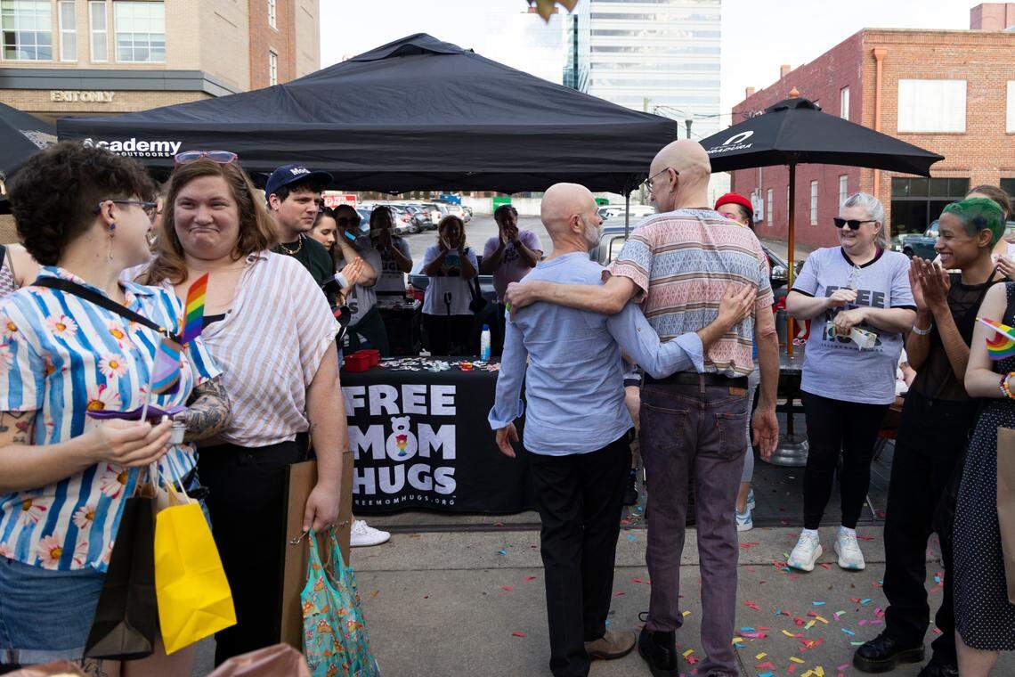 Art fair attendees hold back tears and applaud after James Carpenter and William Bonney’s wedding at Y’all-Mart, a quarterly art fair series, at Art Bar in Columbia, South Carolina on Sunday, February 9, 2025. While each of the eight couples brought friends and family to their weddings, strangers and art fair attendees watched and celebrated the weddings as well.