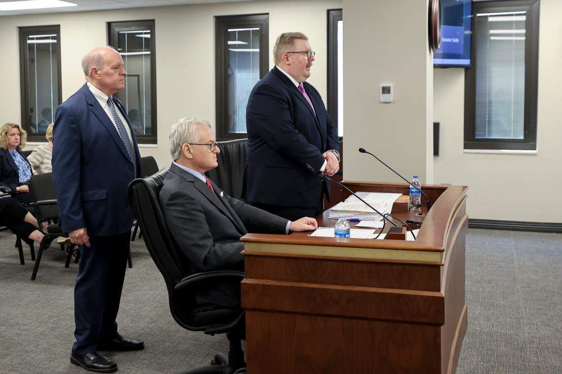 A Sergeant at Arms stands near attorney Shawn Eubanks at the request of state Sen. Larry Grooms, R-Berkeley. Grooms asked that Eubanks be escorted from the room if he continued to speak during a hearing where South Carolina treasurer Curtis Loftis was being questioned by a senate sub-committee on Thursday, Feb. 27, 2025.