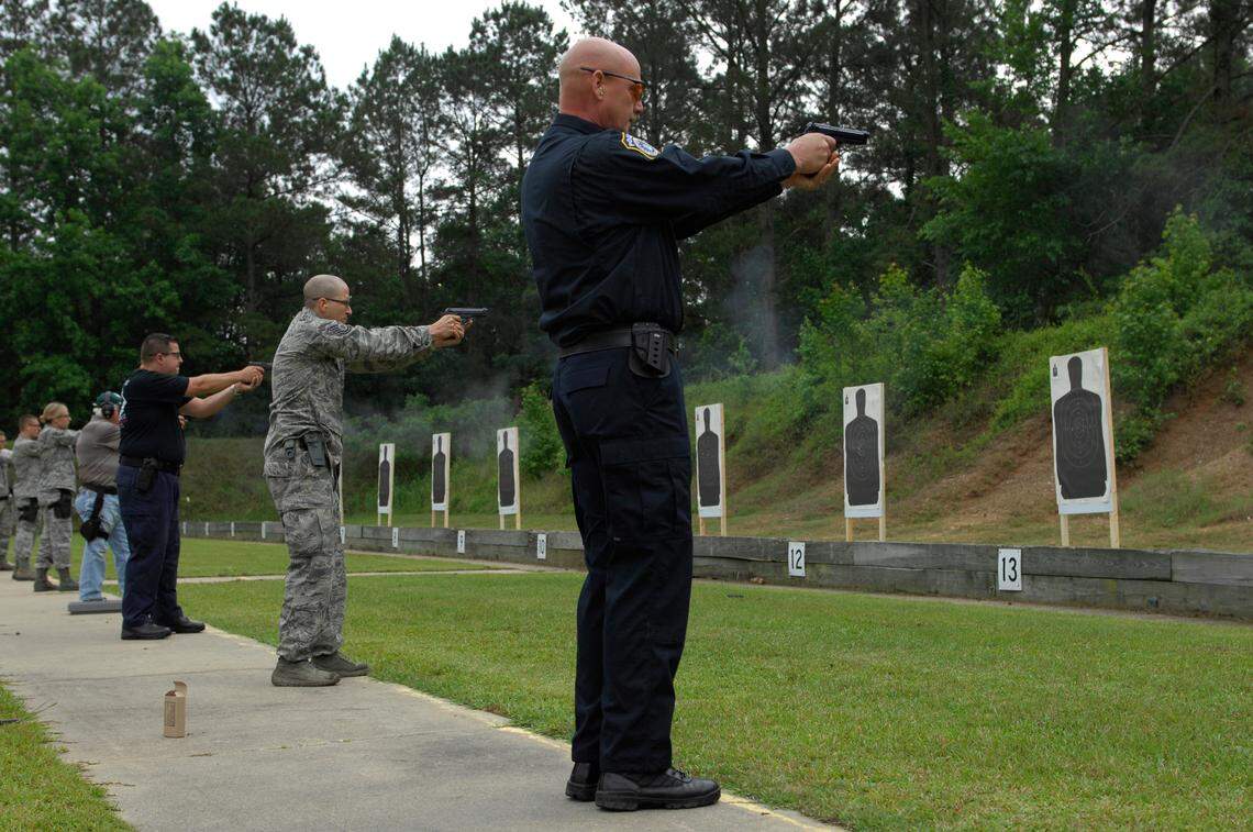 Eric Kaziska, a civilian police officer of the U.S. Air Force Academy’s 20th Security Forces Squadron, along stands alongside Airmen and police officers to compete in a pistol tournament at the Sumter Police Department’s firing range on May 18, 2012. The SPD training facility will see $400,000 for improvements through a hidden earmark from Rep. David Weeks, D-Sumter.