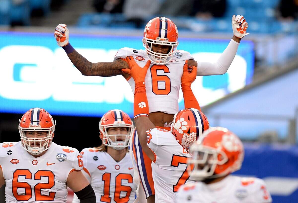 Clemson Tigers wide receiver E.J. Williams is lifted into the air by a teammate after catching a touchdown pass from quarterback Trevor Lawrence during second quarter action against Notre Dame at Bank of America Stadium on Saturday, December 19, 2020 in Charlotte, NC. The Clemson Tigers and Notre Dame Fighting Irish faced off in the ACC Championship game.