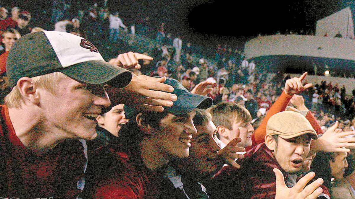 USC quarterback Stephen Garcia celebrates with fans in the student section after defeating Tennessee at William-Brice Stadium in this file photograph. Garcia has been named the starter in USC's bowl game.
