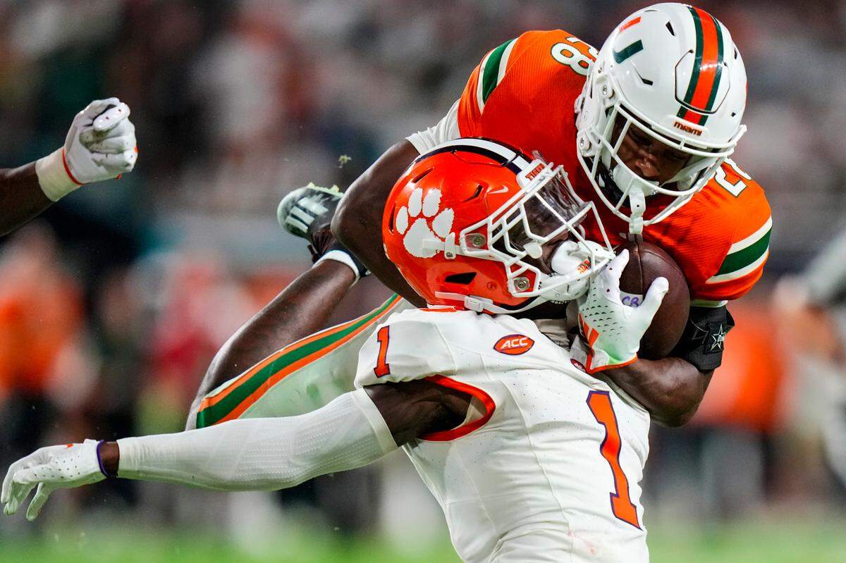 Clemson Tigers safety Andrew Mukuba (1) tackles Miami Hurricanes running back Ajay Allen (28) during over time at Hard Rock Stadium.