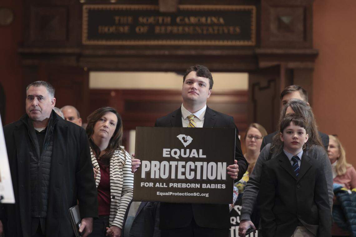 Noah Nix holds a sign during a press conference in the State House lobby on Tuesday, Jan. 13, 2026. During the press conference, Sen. Lee Bright and State Rep. Rob Harris discussed their legislation, The South Carolina Prenatal Equal Protection Act.