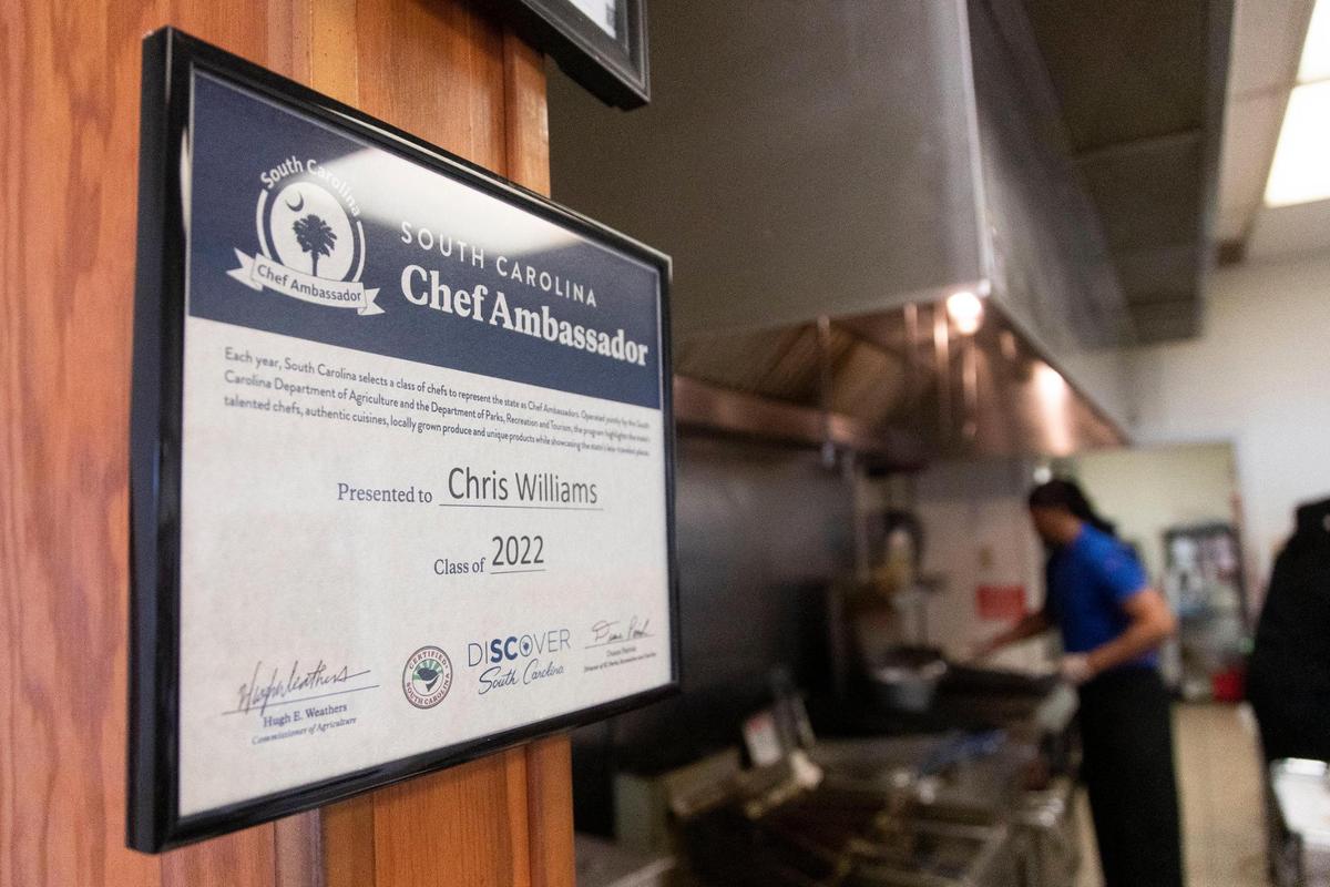 A sign says Chris Williams is a Chef Ambassador at his restaurant, Roy’s Grille, located at a gas station in Lexington, South Carolina on Friday, January 7, 2022.