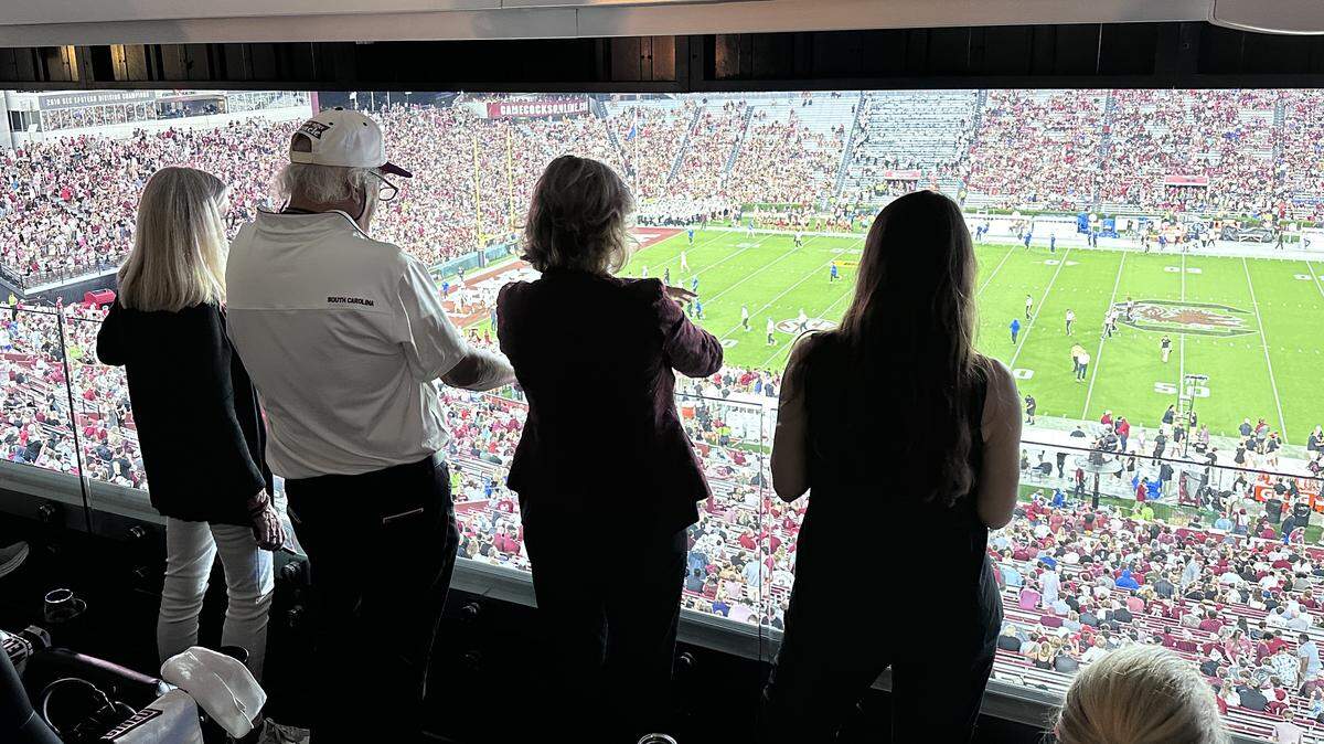 Joe Rice (Center left) watches the USC game with his wife Lisa (Center right) and daughter, Ann E. Rice Ervin (Right).
