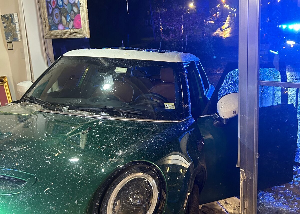 A car crashed into a retail business building.