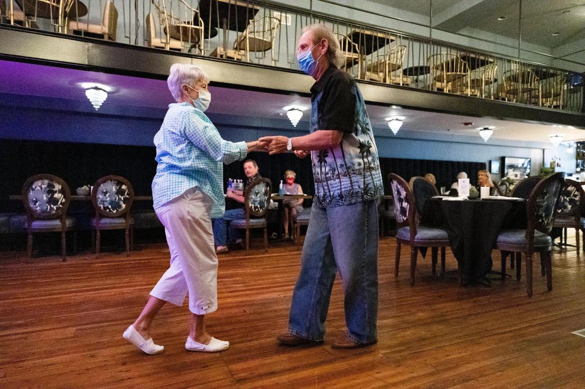 Brenda Davidson and Henry Dowd dance at Main Course in downtown Columbia, South Carolina on Friday, June 26, 2020. After dancing for one song, Dowd said he felt dizzy, but will keep wearing the mask if it allows him to dance.