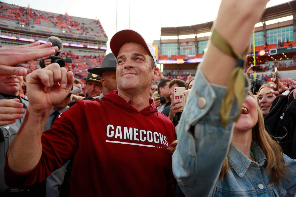 South Carolina Gamecocks head coach Shane Beamer wades through masses of fans after his team beat Clemson on Saturday, November 26, 2022.