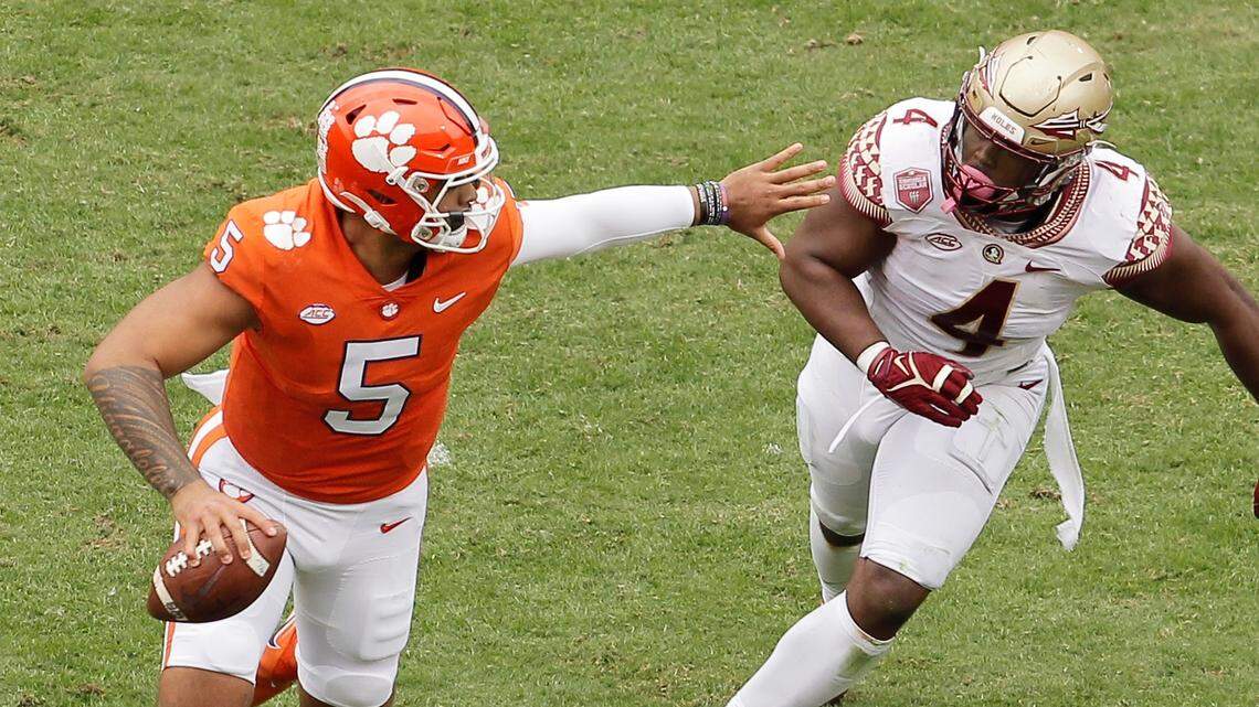 Clemson quarterback D.J. Uiagalelei (5) tries to fend off Florida State defensive end Keir Thomas (4) during second-quarter action on Saturday Oct. 30, 2021 in Clemson, S.C.