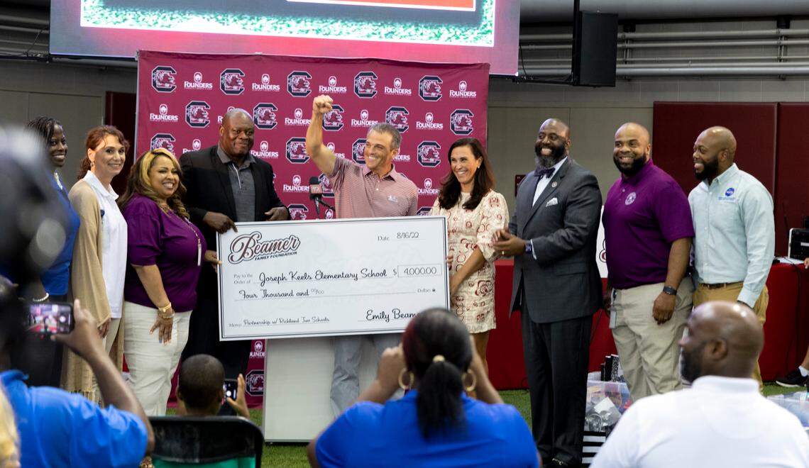University of South Carolina football coach Shane Beamer and his wife Emily pose for a photograph after announcing donations through the Beamer Family Foundation to Forest Lake, Jackson Creek, Joseph Keels and L.W. Conder Elementary Schools.