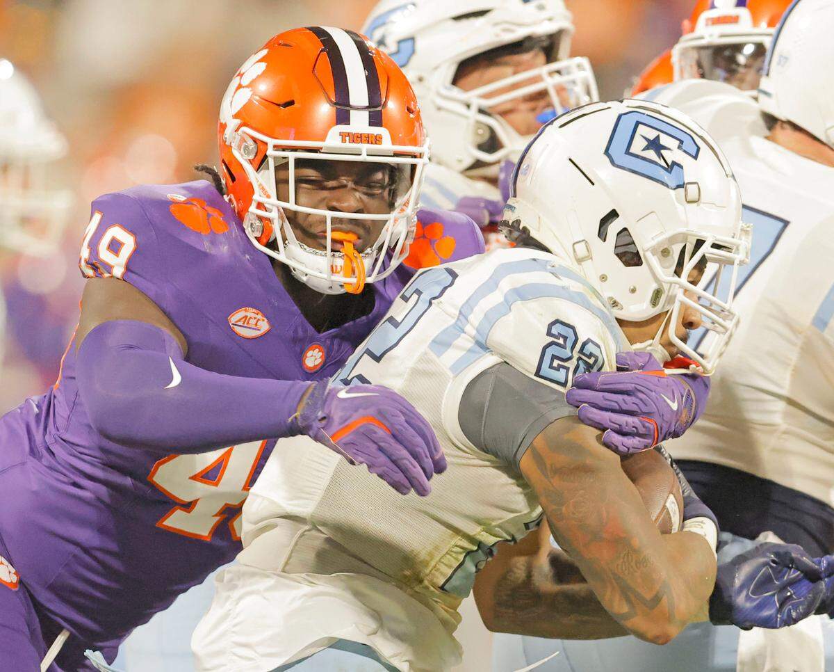 Clemson defensive end Darien Mayo (49) wraps up Citadel running back Garrison Johnson (22) during second-half action in Clemson, S.C. on Saturday, Nov. 23, 2024.