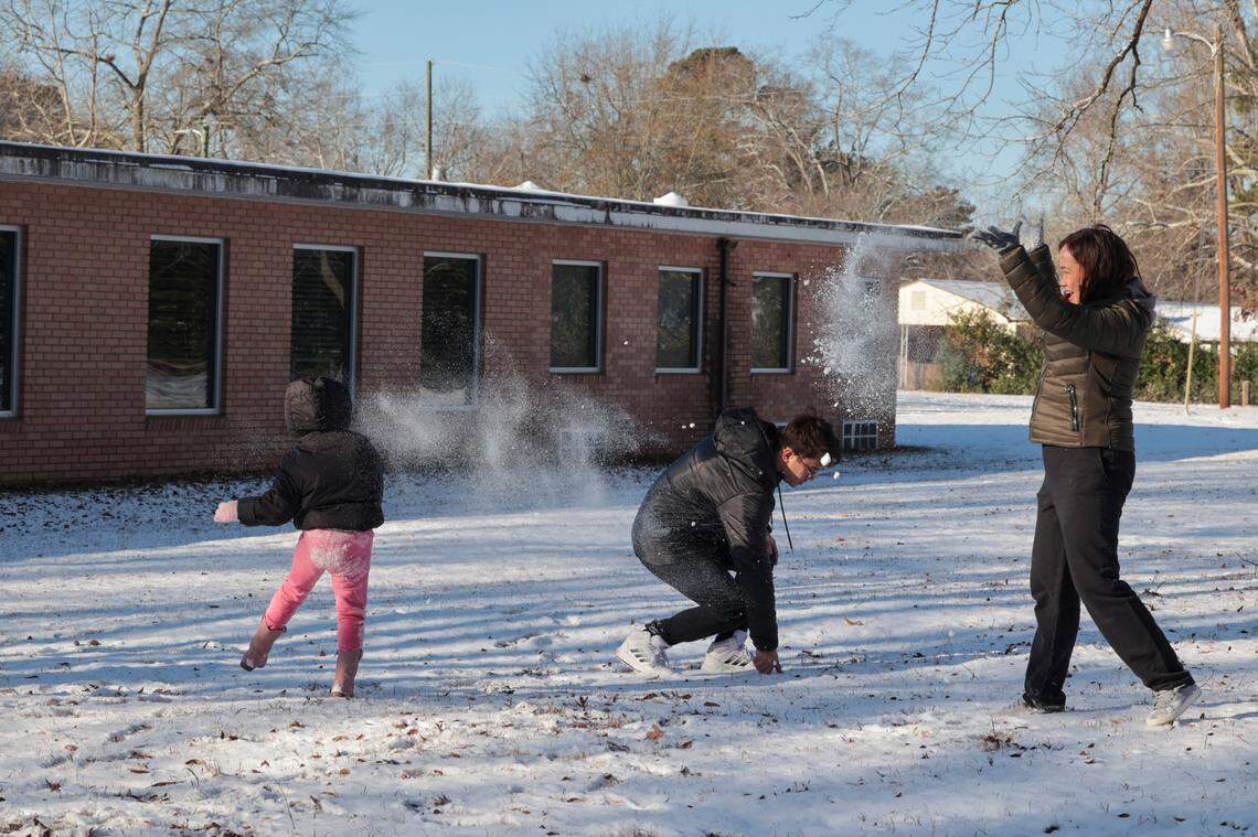 Brie Patel, 5, pelts her father, Alvin Patel with snow while playing in the snow on Wednesday, Jan. 22, 2025, with her family, including her mother, Madel. It was the first snow experience ever for the Patel’s who are in Columbia from the Philippines.