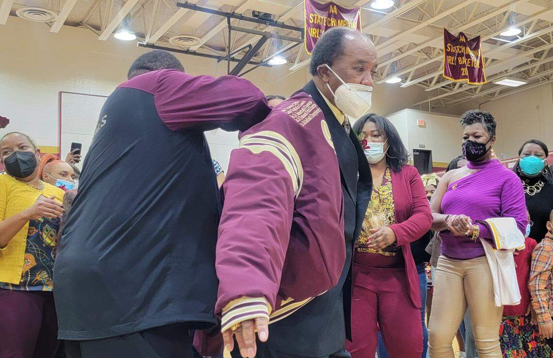 Former Columbia High girls basketball coach Bobby Young receives a comemmorative letterman’s jacket as the school named the gymnasium in his honor on Jan. 28, 2022.