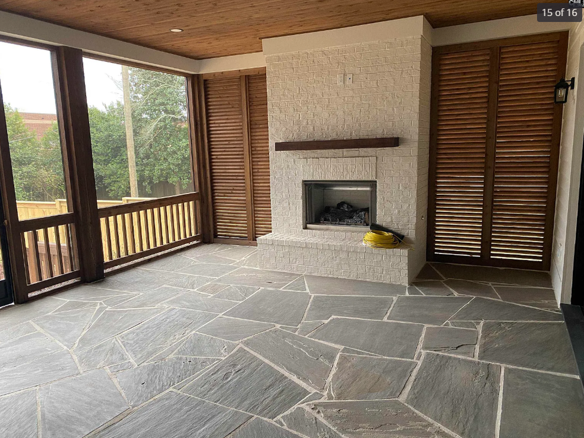A screened porch with a fireplace and multi-slide doors that disappear into the wall is one of the standout features included in a $2.3 million, 5-bedroom new-construction home for sale in Forest Acres.
