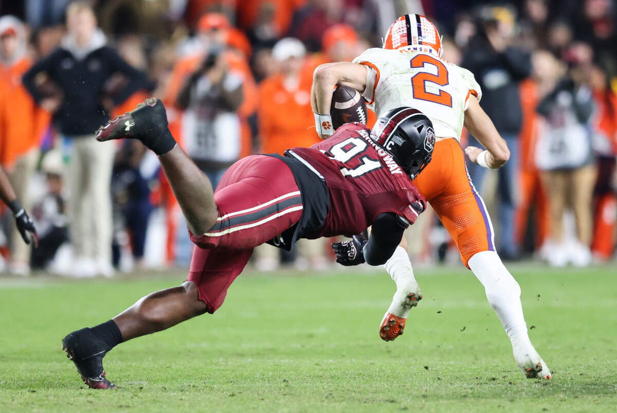 South Carolina defensive tackle Tonka Hemingway (91) dives for Clemson quarterback Cade Klubnik (2) during the second half of South Carolina’s game against Clemson at Williams-Brice Stadium in Columbia on Saturday, November 25, 2023.