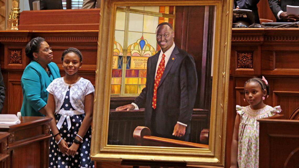 Clementa Pinckney’s wife Jennifer and daughters Eliana and Malana stand next to his portrait after unveiling it during a ceremony inside the Senate chambers of The State House, Wednesday, May 25, 2016.