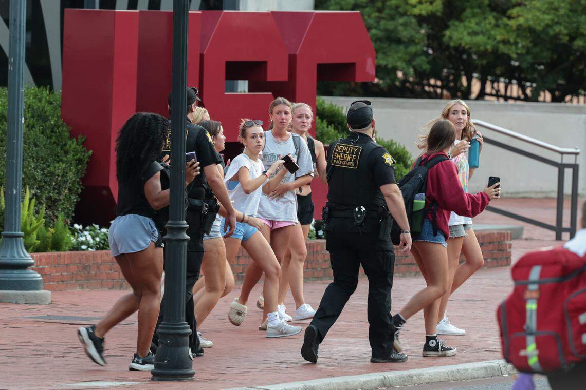 Students get directions from Law enforcement officials after reports of the sounds of gunfire at The University of South Carolina, at the Thomas Cooper Library on Sunday, August 25, 2025.