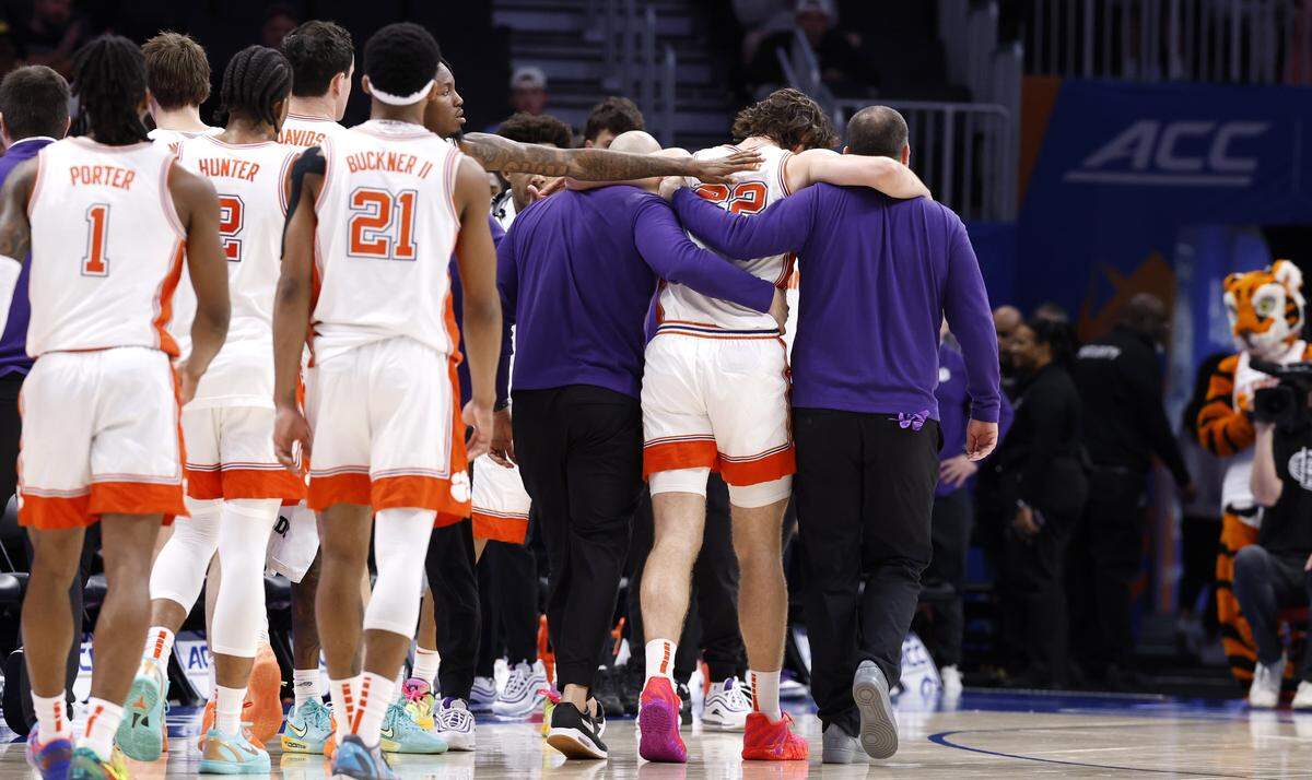 Clemson's Carter Welling (22) is helped off the court after he was injured during the first half of Wake Forest’s game against Clemson in the second round of the 2026 ACC Men’s Basketball Tournament at the Spectrum Center in Charlotte, N.C., Wednesday, March 11, 2026.