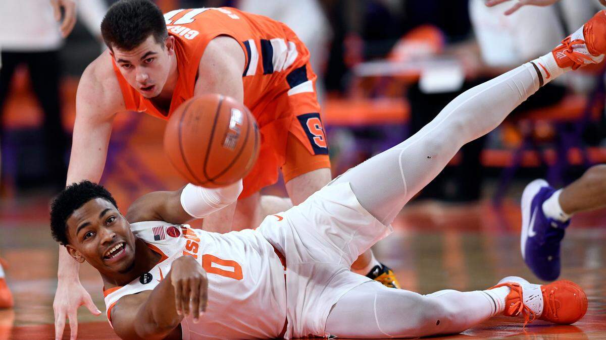 Clemson guard Clyde Trapp (0) comes up with a loose ball past Syracuse guard Joseph Girard III (11) during first half action at Clemson’s Littlejohn Coliseum Saturday, February 6, 2021. ACC Pool/Bart Boatwright/The Clemson Insider