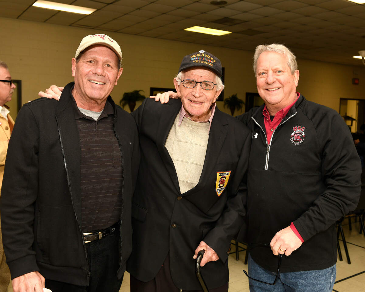 The late R.J. Moore at his 95th birthday party on Feb. 3, 2018, along with former USC football players Jeff Grantz, left, and Jimmy Mitchell.