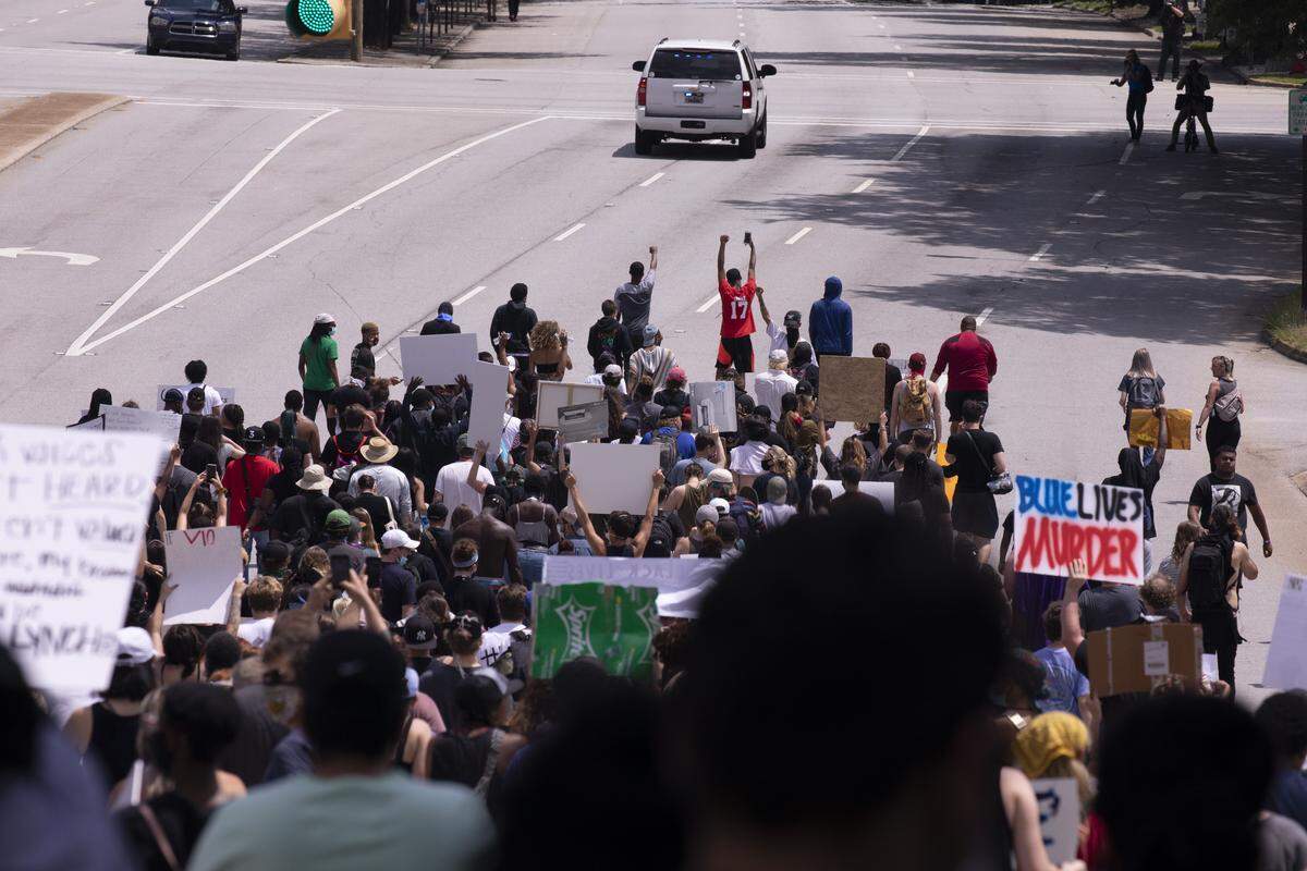 Protesters make their way up Assembly Street before clashing with riot police on Hampton Street Sunday. A protest over the death of George Floyd in Columbia on Sunday resulted in a clash with police on Hampton Street. May 31, 2020