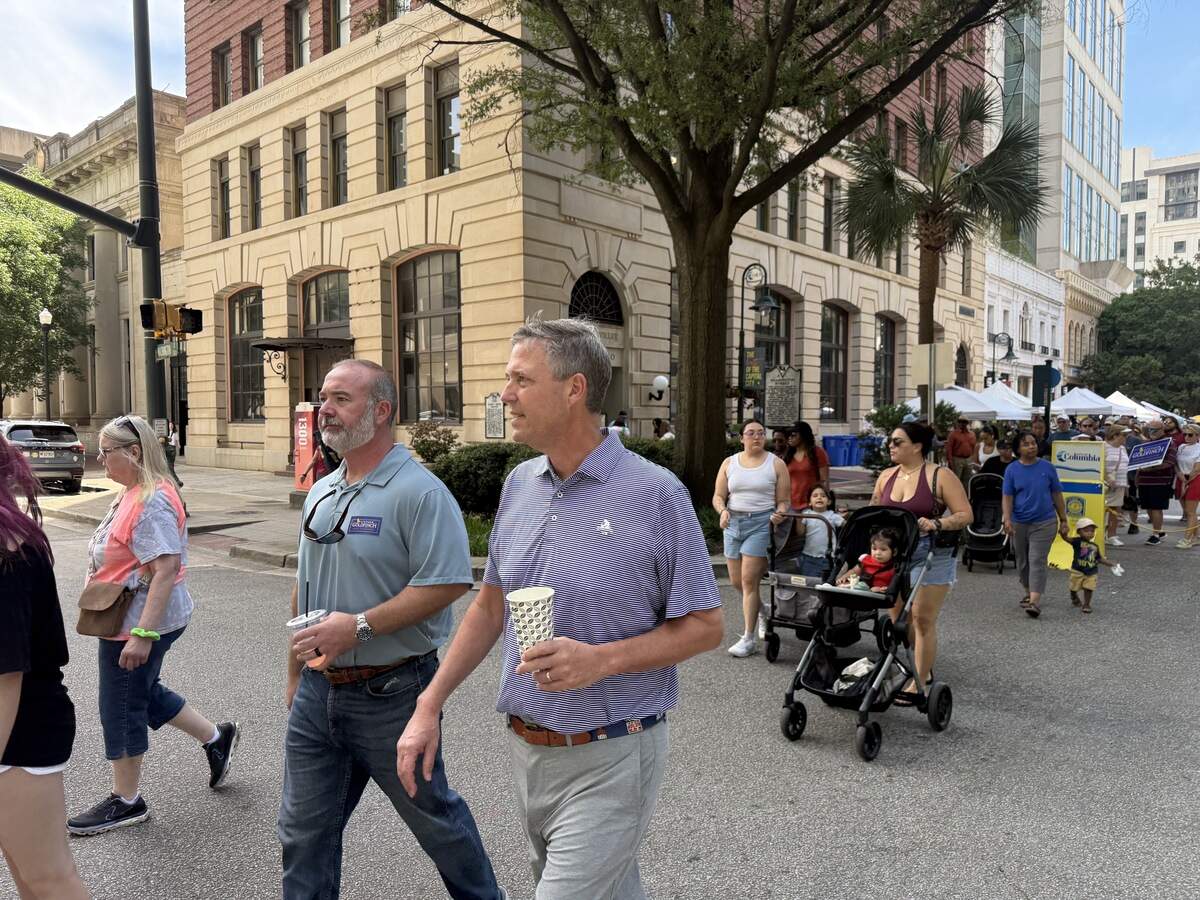 State Sen. Stephen Goldfinch, R-Georgetown, walks Soda City, Columbia’s open-air market, with Mayor Daniel Rickenmann, right, Saturday, June 20, 2026, seeking votes in the Republican primary runoff election for attorney general.