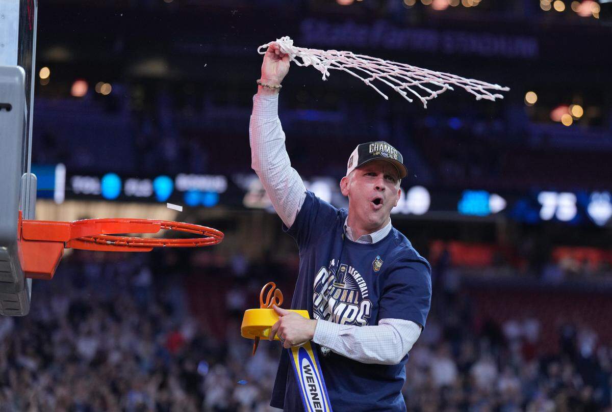 Apr 8, 2024; Glendale, AZ, USA; Connecticut Huskies head coach Dan Hurley celebrates after cutting down the net after defeating the Purdue Boilermakers in the national championship game of the Final Four of the 2024 NCAA Tournament at State Farm Stadium.