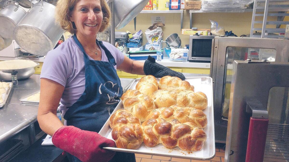 Heidi Lovit shows off a batch of challah, fresh from the oven.