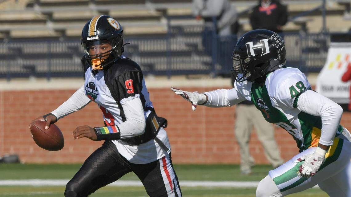 South team quarterback Aaron Brand Jr. (9) of Irmo High runs near North team linebacker Donovan Darden (48) of Havelock High during the first quarter of the 2024 Shrine Bowl of the Carolinas at Viking Stadium in Spartanburg, S.C. Saturday, December 21, 2024.