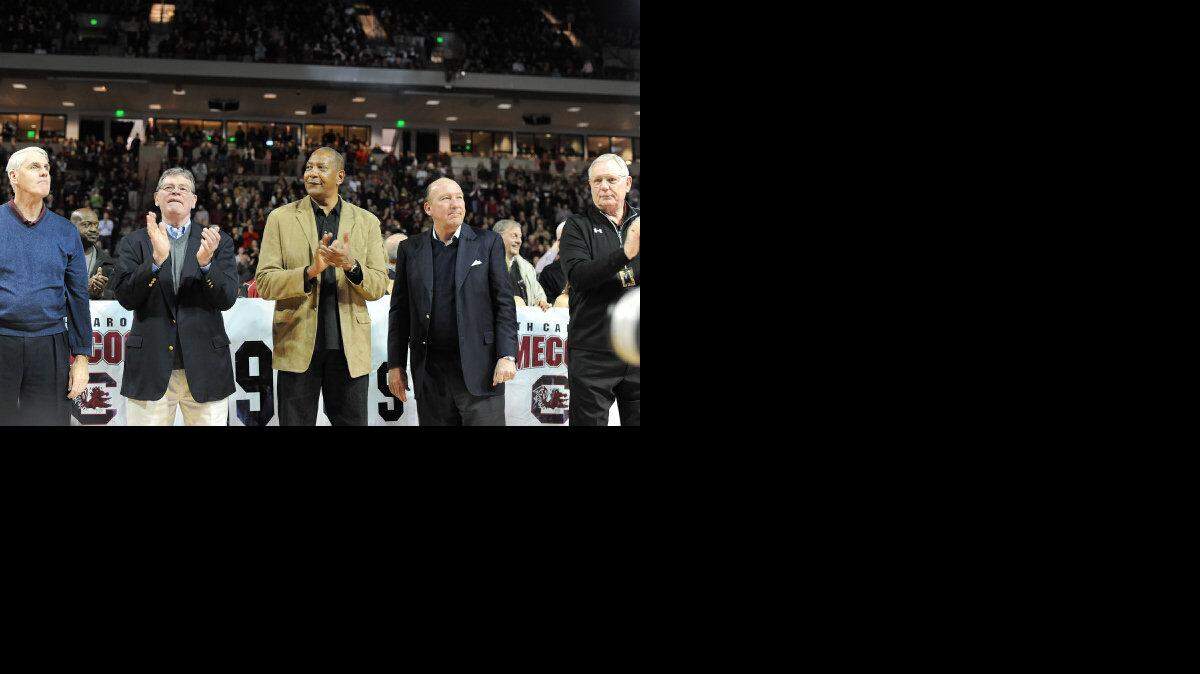 USC basketball legends from the Frank McGuire era, including Alex English (second from left)  and Mike Dunleavy (second from right) take center stage as they return to honor the former USC coaching legend  at Colonial Life Arena before the Gamecocks’ game against Ole Miss on Saturday.