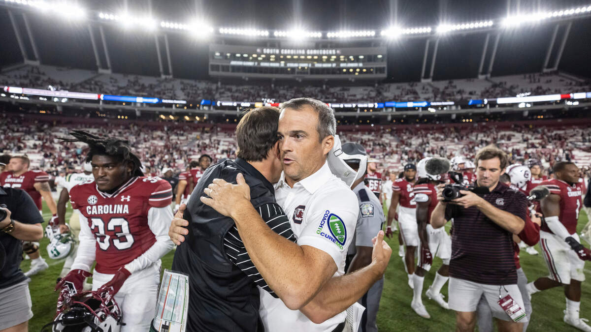 South Carolina head coach Shane Beamer speaks with head coach Will Healy of the University of North Carolina at Charlotte after the Gamecocks’ win at Williams-Brice Stadium in Columbia, SC on Saturday, Sept. 24, 2022.